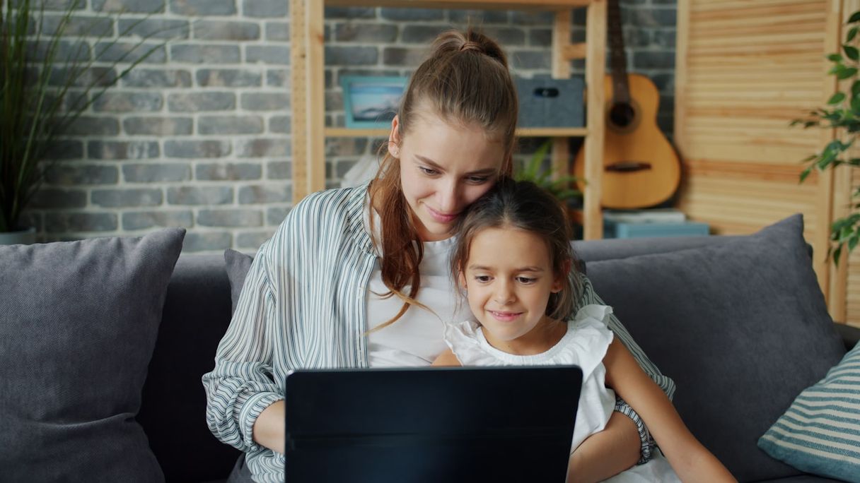 Mother and daughter looking at a laptop together